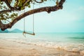 Wooden swing on tropical beach Royalty Free Stock Photo