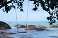 A wooden swing on the tropical island beach under beautiful blue sea and sky, Phuket, Thailand Royalty Free Stock Photo