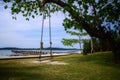 Wooden swing under tree on the beach, Scenery of beautiful destination island, Koh Mak island Royalty Free Stock Photo