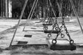 Wooden swings in park, space for text. Black and white effect Royalty Free Stock Photo