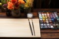 Wooden table adorned with artists essentials, perfect for creative endeavors