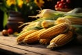 Wooden table adorned with autumns harvest corn creates a rustic still life