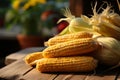 Wooden table adorned with autumns harvest corn creates a rustic still life