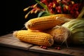 Wooden table adorned with autumns harvest corn creates a rustic still life