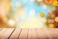 Wooden table with autumn leaves on bokeh background. Mock up for display of product Royalty Free Stock Photo