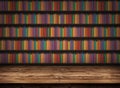 Wooden table on the background of a bookshelf with books. Blurred background with bookshelves. Table top in library. Back