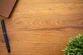 Wooden table background with flower, notebook and pencil