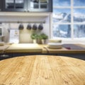 Wooden table background with free space and window and kitchen interior backgound. Winter mountains outside the window. Royalty Free Stock Photo