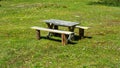 Wooden table and bench in the flower field Royalty Free Stock Photo