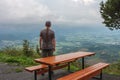 Wooden table and benches, hiker with dreadlocks and view from Velky Javornik to Frenstat nad Radhostem, Beskid Mountains