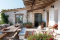 A wooden table and benches are set up on a patio, providing a functional outdoor seating area, A rustic Mediterranean seaside