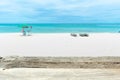 Wooden table on blue sunny sky beach blurred background with beach chairs Royalty Free Stock Photo