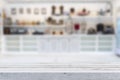 Wooden table on blurred background of kitchen window and shelves Royalty Free Stock Photo