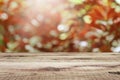 Wooden table and blurred bokeh autumn background.