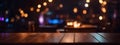 Wooden table, blurred bokeh background background. Neon light, night view, close-up. The general background of the interior, a dar Royalty Free Stock Photo