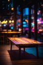 Wooden table, blurred bokeh background background. Neon light, night view, close-up. The general background of the interior, a dar Royalty Free Stock Photo