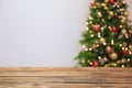 Wooden table and blurred Christmas tree