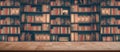 Wooden table in blurred Image Many old books on bookshelf in library Royalty Free Stock Photo