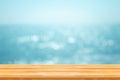 Wooden table with Blurred image of Tropical beautiful seascape view of blue sea and sky with bokeh sunlight. Royalty Free Stock Photo