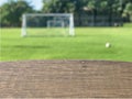 Wooden table with blurred of small soccer field background