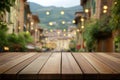 Wooden table with blurred street lights and greenery Royalty Free Stock Photo