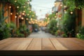Wooden table with blurred street lights and greenery Royalty Free Stock Photo
