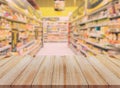 Wooden table with blurred supermarket background