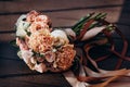 On a wooden table are the bride`s wedding bouquet. The bouquet consists of roses, carnations, eucalyptus leaves. Royalty Free Stock Photo