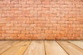 Wooden table of brown on front red brick background, for present