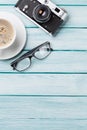 Wooden table with camera, glasses and coffee Royalty Free Stock Photo