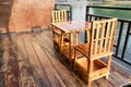Wooden table and chair on the terrace near the river in the morning scene