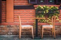 Wooden table and chairs and brick wall in coffee shop cafe Royalty Free Stock Photo