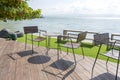 Wooden table and chairs in empty beach cafe next to sea water. Island Koh Phangan, Thailand Royalty Free Stock Photo