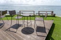 Wooden table and chairs in empty beach cafe next to sea water. Island Koh Phangan, Thailand Royalty Free Stock Photo