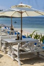 Wooden table and chairs in empty beach cafe next to sea water. Island Koh Phangan, Thailand Royalty Free Stock Photo