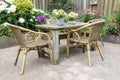 Wooden table and chairs in a ornamental garden Royalty Free Stock Photo