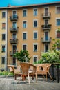 Wooden table and chairs on an outdoor terrace in a residential neighbourhood during the summer. Royalty Free Stock Photo