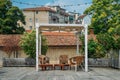 Wooden table and chairs on an outdoor terrace in a residential neighbourhood during the summer. Royalty Free Stock Photo