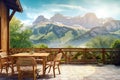 Wooden table and chairs on rustic beautiful terrace in hotel with stunning mountain view. Summer holiday or vacation concept