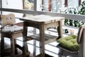 Wooden table and chairs with seat cushions on the terrace at home in winter Royalty Free Stock Photo