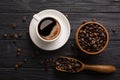 Wooden table with coffee beans in scoop composition. Vintage wood background texture and old spoons with grains top view Royalty Free Stock Photo