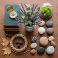 On a wooden table, a collection of objects creates a harmonious display. A stack of books topped Royalty Free Stock Photo