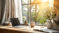 A wooden table with a computer, laptop, smartphone, and coffee cup beside the window balcony with sunlight shining through the Royalty Free Stock Photo