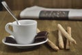 A wooden table with cup of coffee and chocolate pieces with sticks. Royalty Free Stock Photo