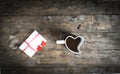 Cup in the shape of a heart and love letter on wooden table Royalty Free Stock Photo