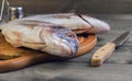 Wooden table cutting board with fresh raw dorado fish Royalty Free Stock Photo