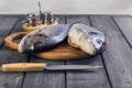 Wooden table cutting board with fresh raw dorado fish Royalty Free Stock Photo