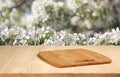 Wooden table with cutting Board on a spring blurred background