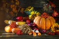 The wooden table decorated with vegetables, pumpkins and autumn leaves. Autumn background. Schastlivy von Thanksgiving