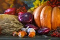 The wooden table decorated with vegetables, pumpkins and autumn leaves. Autumn background. Schastlivy von Thanksgiving